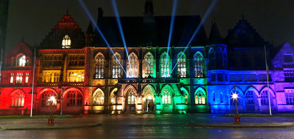 A town hall illuminated with coloured lighting for a Christmas Light Switch On.