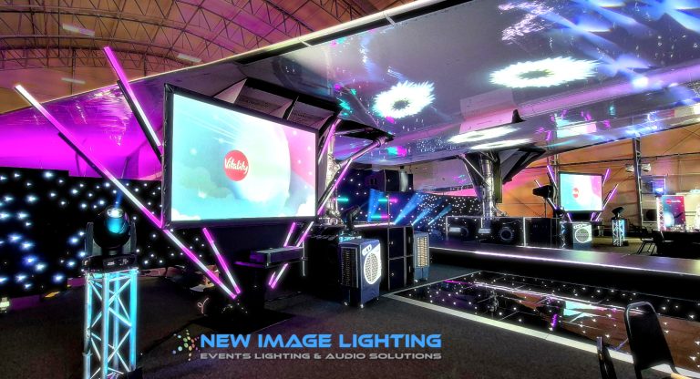 Projection screen at the Concorde Conference Centre with stage and lighting beneath the Concorde plane